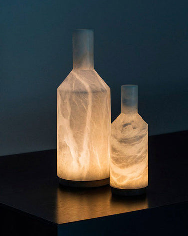 Carpyen Alabaster battery-operated table lamps glowing on a dark shelf