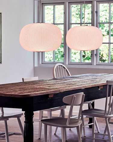 Le Klint Lamella pendants over a wooden dining table