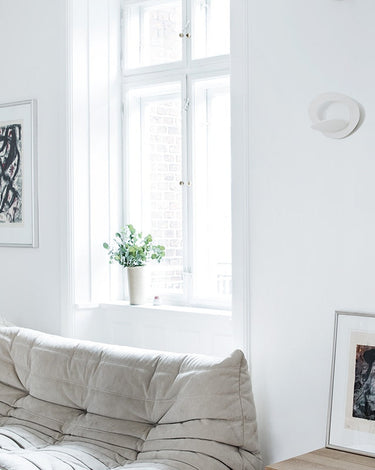 Artemide Pirce wall lights in a bright small living room