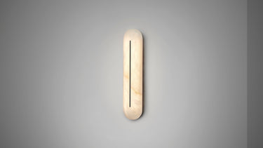 Hepworth wall light in bronze with a rounded honed alabaster panel and a fine dark central line, lit on a grey wall