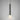Tall Torres pendant in bronze with a honed alabaster shade against a grey studio wall
