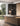 Penta Clip pendants above a kitchen island with garden windows and dark curtains behind