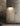 Dark Penta Enoki wall sconce beside a door