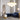 Cloudesley chandelier in satin brass above a blue velvet sofa in a room with arched doorways