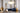 Cloudesley chandelier in satin brass above a blue velvet sofa in a room with arched doorways