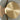 Close-up of the brass disc and smoked glass shade of the Pendulum floor lamp, lit