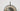 Close-up of the bronze disc and smoked glass shade of the Pendulum floor lamp
