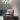 Group of three Abstract wall lights above a pink velvet armchair and a round black pouf