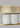 Row of white alabaster cylinders under a satin brass band on an Avalon chandelier