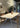 Ilo horizontal pendant hung above a marble dining table with wooden chairs