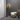 Pendulum floor lamp and two Pendulum wall lights in a grey room with an armchair
