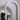 Lucid table lamp with a honed alabaster dome on a brass base, in a room setting