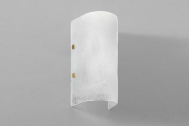 Whistler wall light with a curved, frosted fritted glass shade and two brass pins, studio view