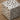 Stainless steel AMS cube lamp with a cut-out pattern on a wooden surface