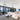 ET2 Alumilux Aster starburst pendants above a white sectional in an open living room with glass walls