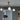 Array Mini pendant with three lit opal glass globes hanging from a ceiling