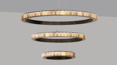 Avalon Triple chandelier, three rings of honed alabaster cylinders in a bronze frame, studio view