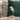 Aqua Blue Bird lamp by Daqiconcept among green and white cushions