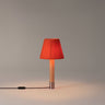 Elegant Basica M1 bedside table lamp by Santa & Cole with soft ambient illumination, Red-Amber Ribbon Shade