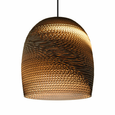 Graypants natural recycled cardboard Bell pendant light hanging in a modern living room.