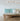 ET2 Blossom long branch pendant above a daybed sofa with teal cushions