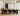 ET2 Blossom long branch pendant over a long dark dining table in a room with tall windows