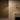 Two Relic wall lights on a warm wall beside a dark panel and a plastered fireplace