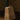 Close-up of the honed travertine base of the Roc lamp with its pitted, sand-colored surface
