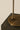 Close-up of the bronze round base and stem of the Heron table lamp