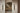 Two Modulo Triple wall lights either side of an arched mirror above a staircase