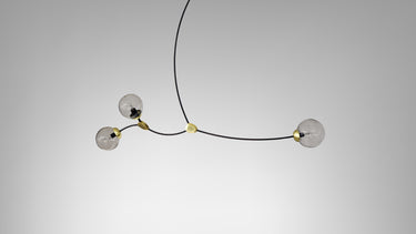 Ivy 3 pendant in bronze with satin brass details and 3 smoked glass globes, studio view