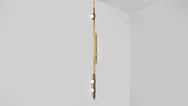 Modulo Vertical pendant light in satin brass, studio view