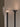 Close-up of the Torres floor lamp in bronze with its alabaster shade beside the plain bronze funnel