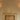 Pair of Relic wall lights with alabaster shades either side of a framed picture above a brick fireplace