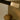 Close-up of a liquid cast glass shade at the end of a bronze strand on the Trace Linear chandelier