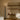 Torres floor lamp with a honed alabaster shade glowing beside a built-in shelf and two cream curved sofas