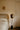 Pendulum floor lamp beside a bed in a bedroom