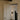 Ring wall light lit in a hallway beside a paneled door