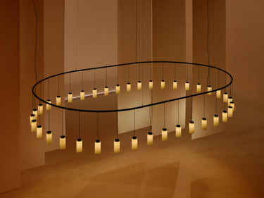 Cirio Oval LED chandelier by Santa & Cole with warm pendant lights