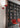 Oluce Colombo wall lamp in scarlet red mounted on a wall in a styled room