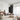 ET2 Continuum linear pendants run along the ceiling of a living room with a cream sectional and sheer curtains