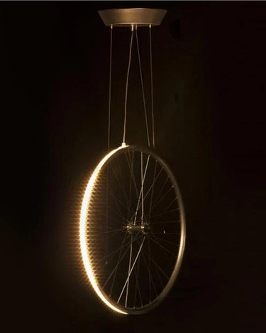 Eddy by Cyclampa glowing at night, a ring of LED light on a bicycle wheel