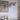 Oluce Dancing Glass suspension lamp hanging over a dining table, lifestyle view
