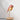 Daqiconcept Bird LED Dimmable Table Lamp - Burnt Brick BR01BBL illuminating a book on a bedside table