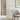 Dessau 46 inch warm brass LED floor lamp providing focused reading light next to an armchair.
