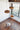 Natural Disc pendants at different heights above a chair by a window, Graypants Scraplights cluster