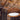 Warm ambient lighting from a natural cardboard Drum pendant in a dining area.