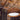 Warm ambient lighting from a natural cardboard Drum pendant in a dining area.