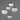 ET2 Nimbus 5-light pendant, white glass shades hanging at different heights against a gray wall