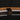 ET2 Kaia 36 in Antique Bronze ring close-up of the suspension bracket and rattan wrap on a dark background